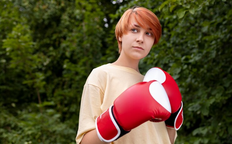 Free Photo portrait of confident redhead girl with boxing gloves