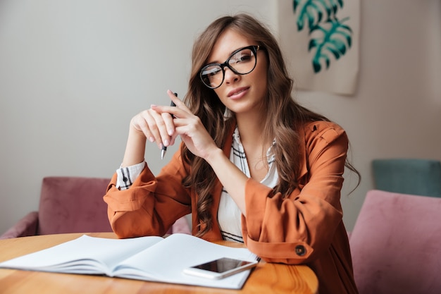 Portrait of a confident woman sitting at the table