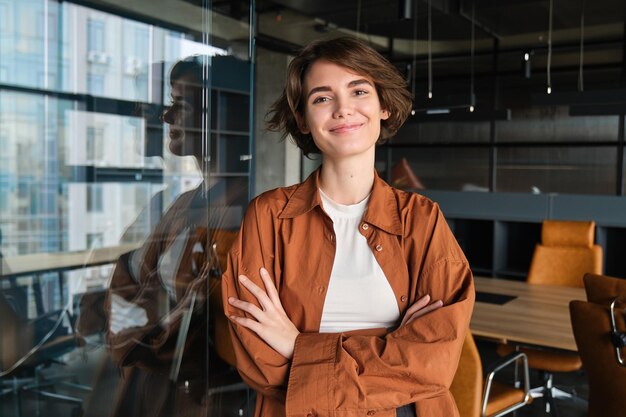 Portrait of confident young businesswoman digital nomad posing in her office wearing casual clothes