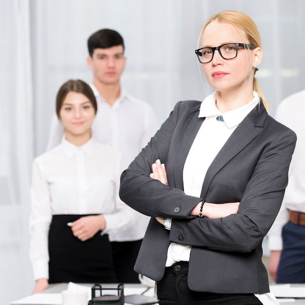 Portrait of confident young businesswoman with her colleague