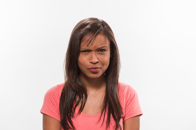 Portrait of a confused teenage girl on white background