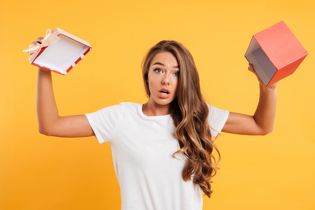 Portrait of a confused young girl showing empty gift box