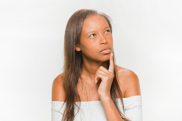 Portrait of a contemplated teenage girl on white background