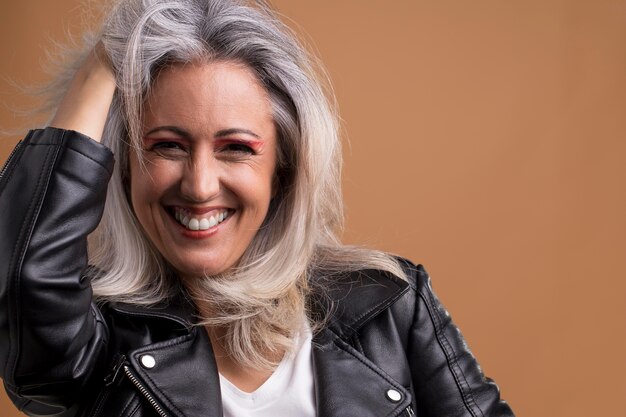 Portrait of cool older woman in leather jacket