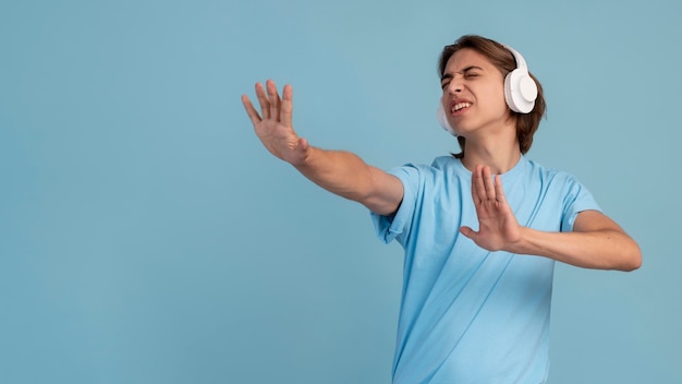 Portrait of cool teen boy listening to music