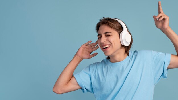 Portrait of cool teen boy listening to music