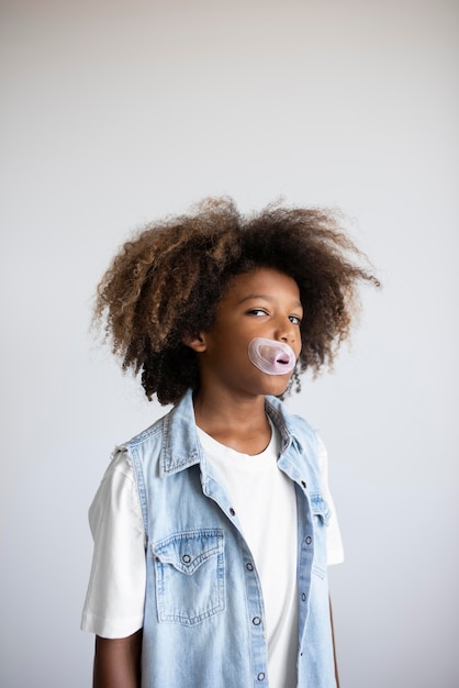 Portrait of cool teenage boy blowing bubbles