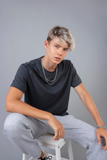 Portrait of cool teenage boy posing on a chair