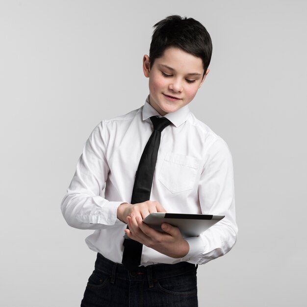 Portrait of corporate young boy holding tablet