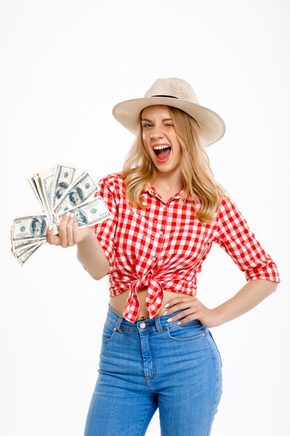 Portrait of country woman holding money on white.