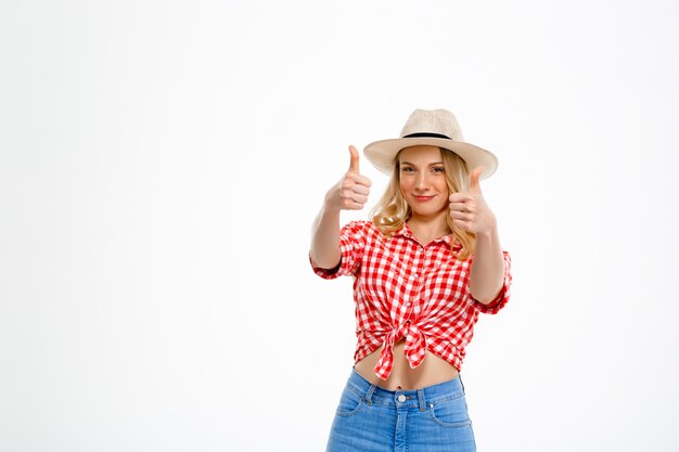 Portrait of country woman showing okay on white.