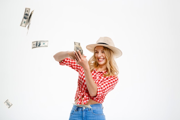 Portrait of country woman throwing money on white.