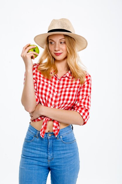 Portrait of country woman with apple on white.