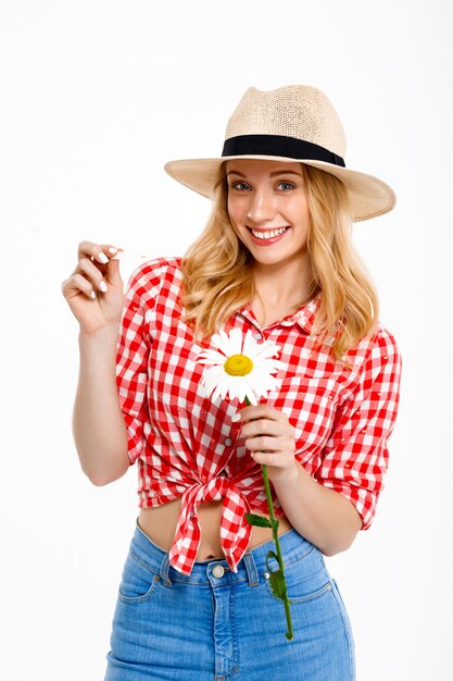 Portrait of country woman with chamomile on white.