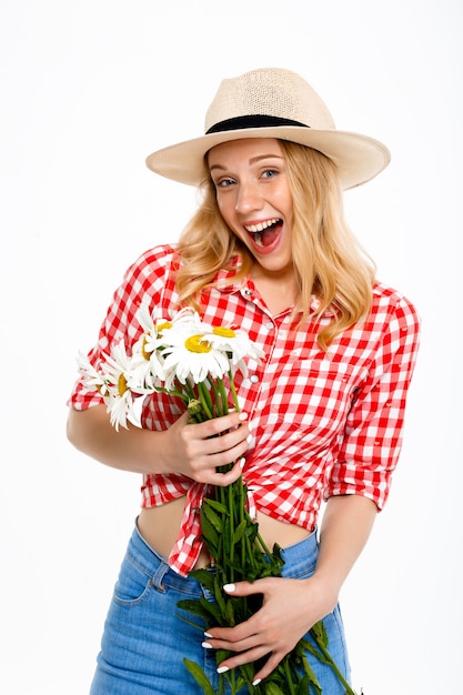 Portrait of country woman with chamomiles on white.