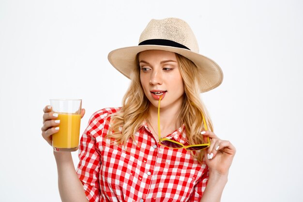 Portrait of country woman with juice on white.