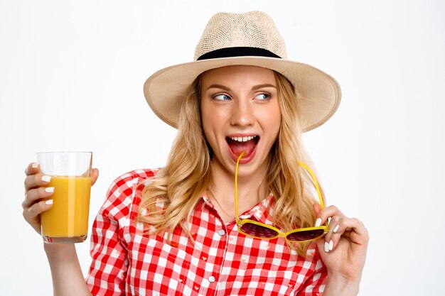 Portrait of country woman with juice on white.