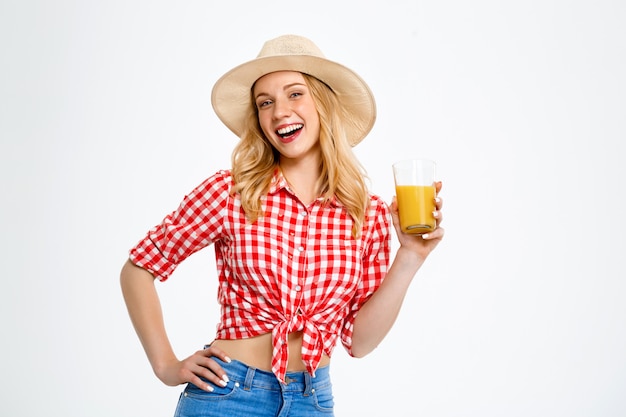 Portrait of country woman with juice on white.