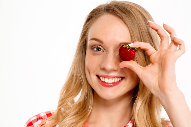 Portrait of country woman with strawberry on white.