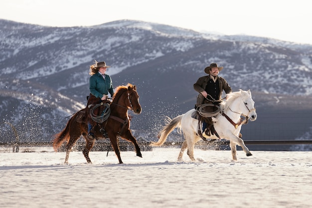 Portrait of couple galloping on horses