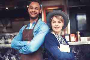 Free photo portrait of couple selling food on the street