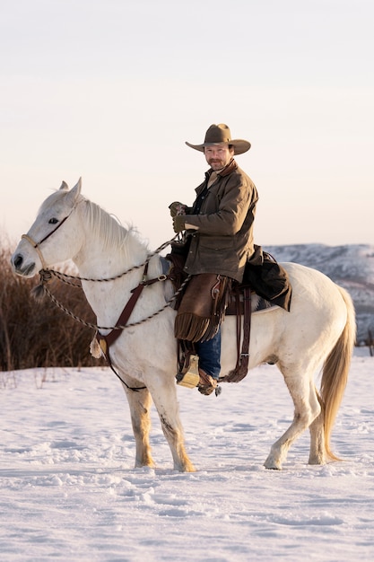 Free photo portrait of cowboy on a horse