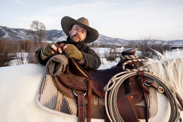 Portrait of cowboy with white horse