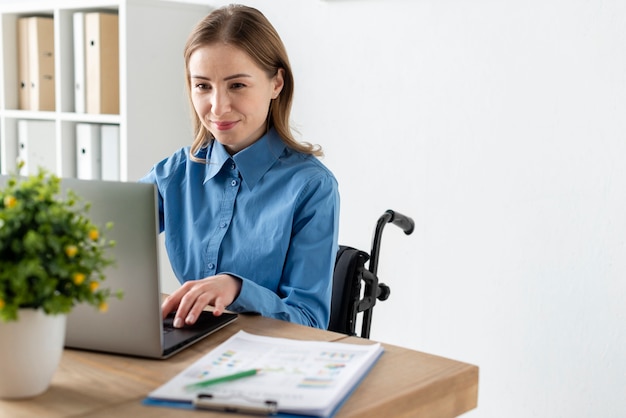 Portrait of cute adult woman working on a laptop