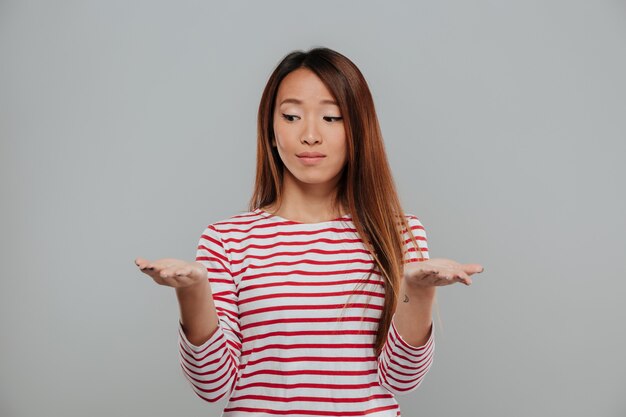 Portrait of a cute asian woman showing her palms