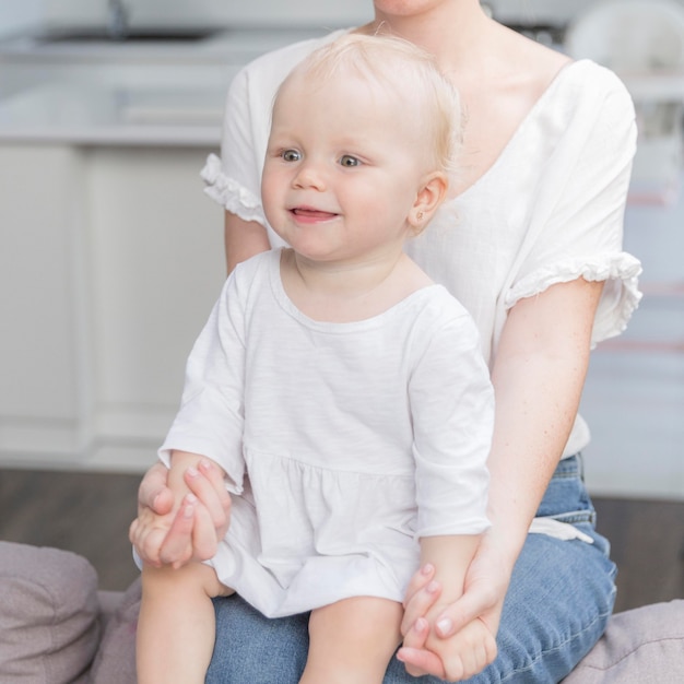 Portrait of cute baby girl together with mom