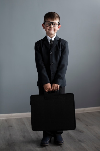 Portrait of cute child with suit and briefcase