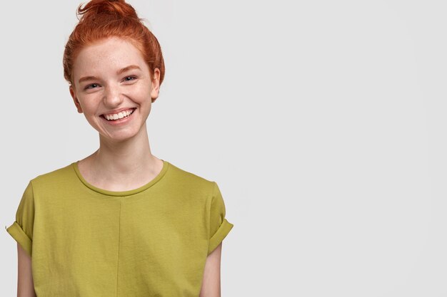 Portrait of cute ginger woman in green T-shirt