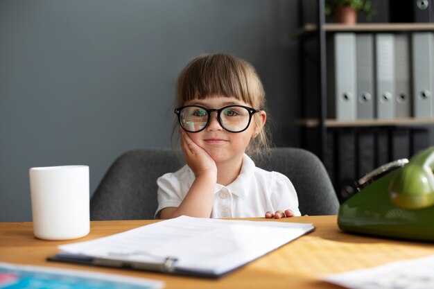 Portrait of cute girl with glasses working in the office
