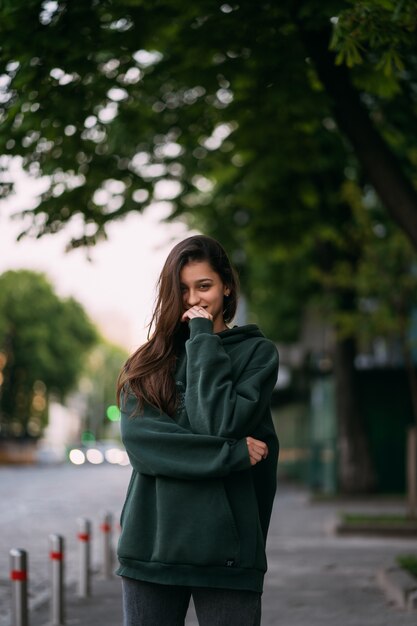 Portrait of cute girl with long hair looks at the camera