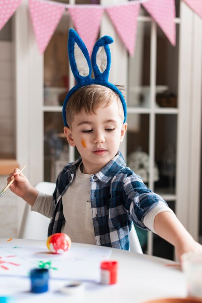 Portrait of cute little boy playing with easter eggs