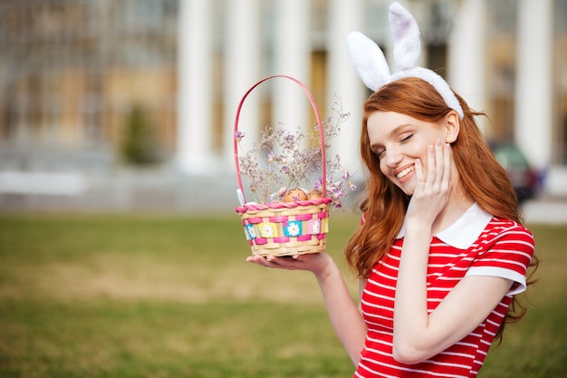 Free photo portrait of a cute red head woman in bunny ears