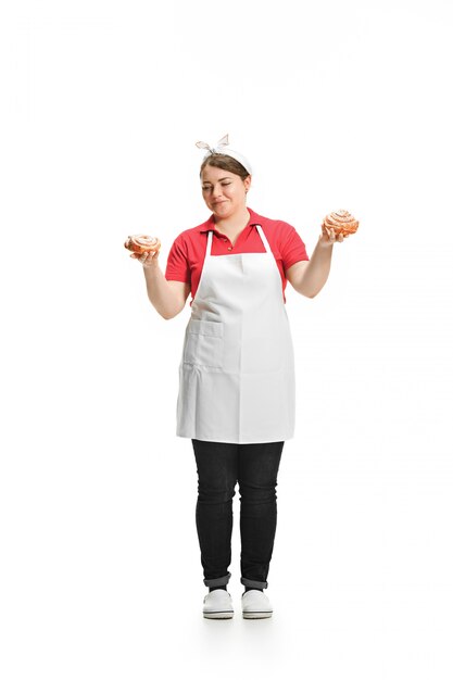 Portrait of cute smiling woman with pastries in her hands