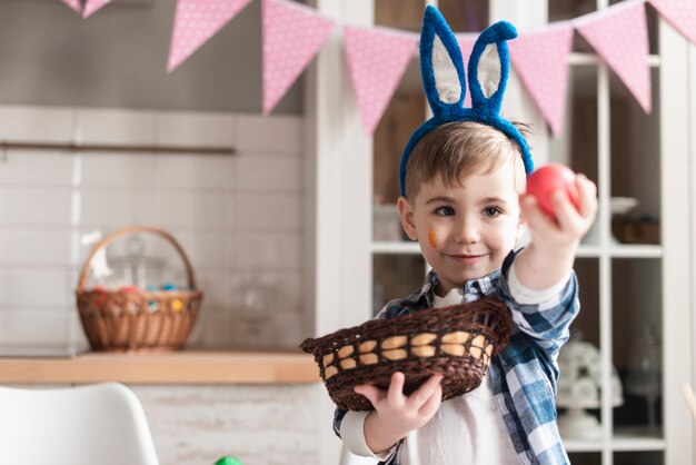 Portrait of cute young boy holding an easter egg