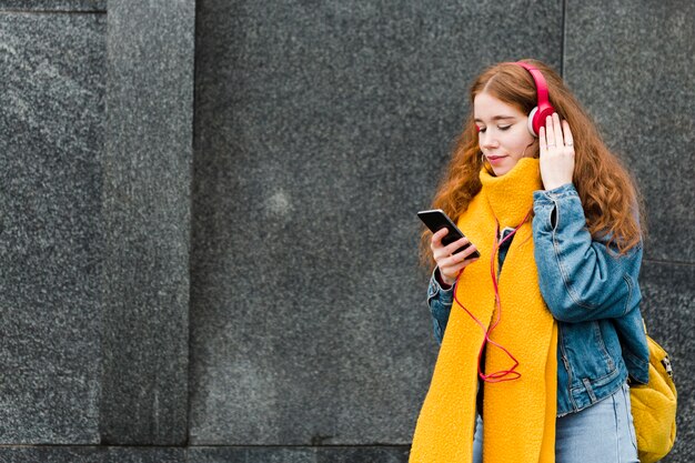 Portrait of cute young girl listening to music