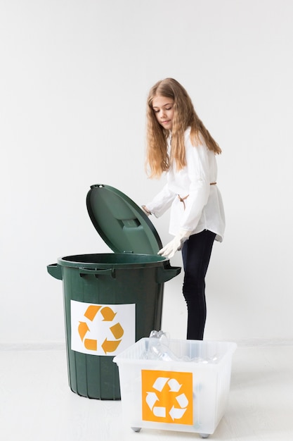 Free photo portrait of cute young girl recycling