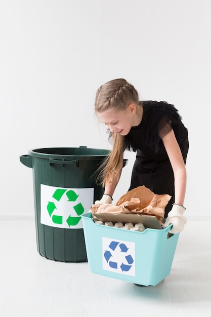 Portrait of cute young girl recycling