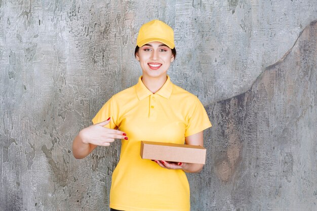 Portrait of delivery employee woman holding cardboard box