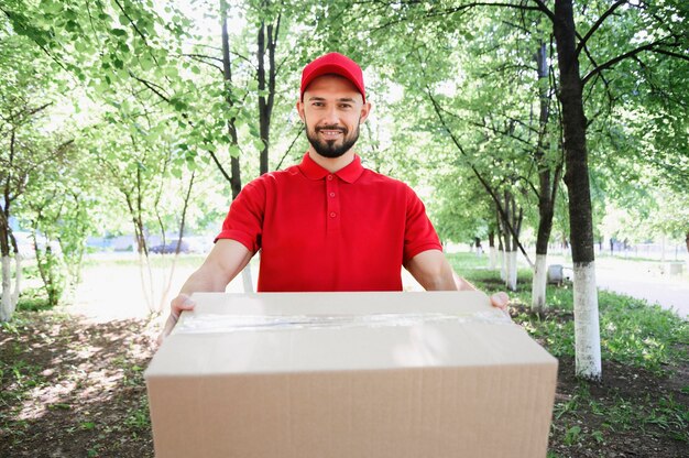 Portrait of delivery man handing out parcel