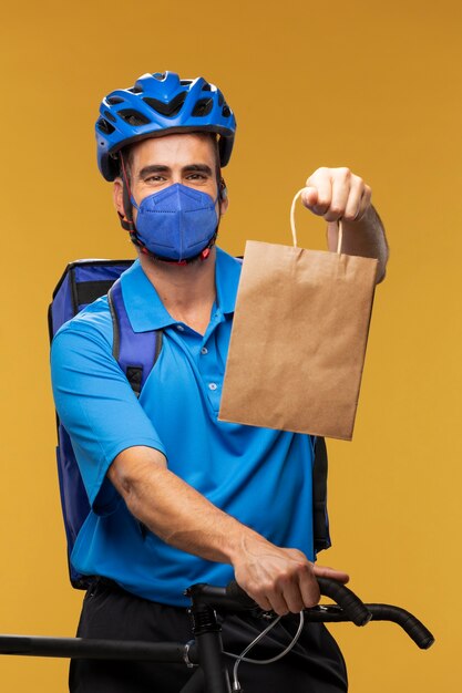 Portrait of delivery man handing out parcel