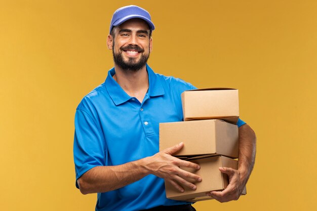 Portrait of delivery man holding cardboard parcel