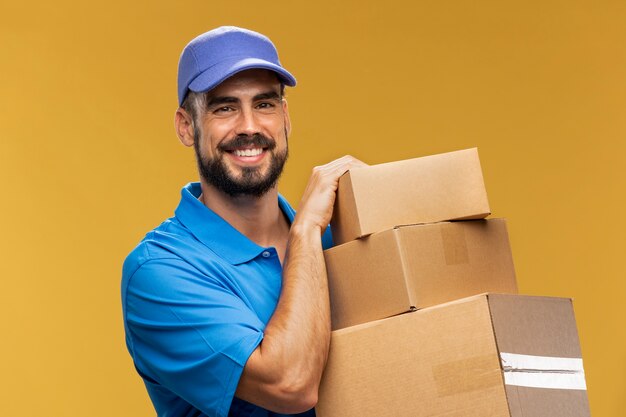 Portrait of delivery man holding cardboard parcel