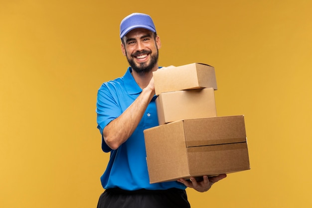 Portrait of delivery man holding cardboard parcel