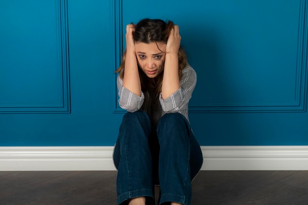 Free photo portrait of the depressed girl sitting on the floor and crying. high quality photo