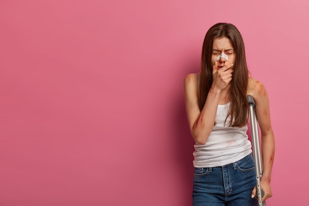 Portrait of depressed young woman suffers from traumatic pain