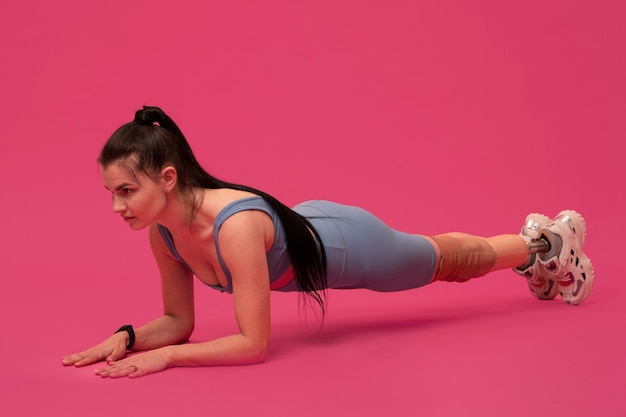 Portrait of disabled woman with prosthetic leg working out